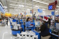 FILE - Customers shop at a Walmart store.