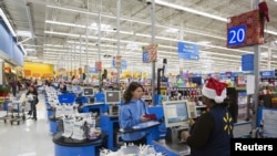 FILE - U.S. customer shops at Walmart, which has warned along with other major U.S. businesses, that prices for shoppers will rise due to higher tariffs on goods from China. 
