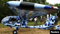 Rangers look at an anti-poaching aircraft named Seeker, which is being shown to reporters at the Kruger National Park in South Africa, December 4, 2012.