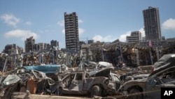 FILE - Damaged cars remain at the site of the Aug. 4 blast in the port of Beirut that killed scores and wounded thousands, in Beirut, Lebanon, Aug. 17, 2020. 