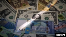 Kazakhstan's tenge and U.S. dollar banknotes are seen together in Almaty, Kazakhstan, Aug. 21, 2015. 