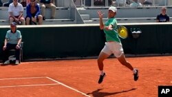 China's Shang Juncheng plays a shot against Peru's Juan Pablo Varillas during their first round match of the French Open tennis tournament at the Roland Garros stadium in Paris, May 29, 2023.