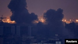 Smoke billows over Beirut's southern suburbs after a strike, amid ongoing hostilities between Hezbollah and Israeli forces, as seen from Sin El Fil, Lebanon, Oct. 9, 2024.