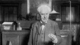 File - Thomas Edison presses a button in West Orange, N.J., in 1928. The button turns on street lights in Seattle. (AP Photo)