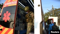 Army soldiers check an ambulance at the Penitenciaria del Litoral jail after prisoners died and others were injured in a riot in Guayaquil, Ecuador, Sept. 28, 2021. 