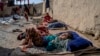 FILE - A sick and disabled girl lies in the open air in a camp for internally displaced families on the outskirts of Kabul, Afghanistan, Feb 6, 2023. The U.N. refugee agency says there are 3.2 million internally displaced people in Afghanistan.