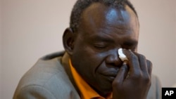 Clement Abaifouta, president of the association of victims of former Chadian dictator Hissène Habré , wipes away tears while listening to fellow victims recount their stories, at a press conference in Dakar, Senegal, Wednesday, July 17, 2013. Abaifouta, arrested in 1985, said he was forced for four years to dig graves for hundreds of prisoners. A lawyer said more than 1,000 victims of Habré have formally asked to participate in his trial on charges of war crimes, crimes against humanity and torture. (AP Photo/Rebecca Blackwell)