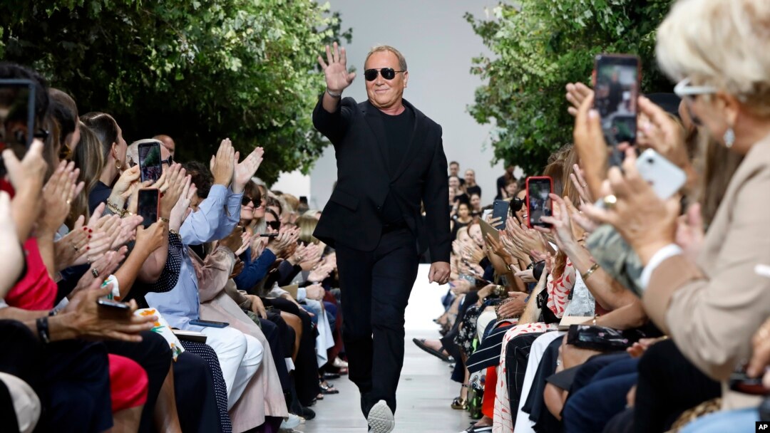 Designer Michael Kors is applauded on the runway after his collection was modeled during Fashion Week in New York, Sept. 11, 2019.