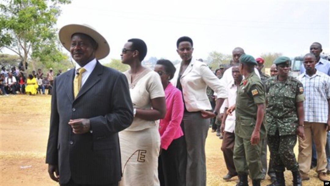 Uganda's President Yoweri Kaguta Museveni, wearing hat at left, stands in a queue as he waits with other voters to place his ballot in Kiruhura district, which is Museveni's home area, at a Polling station about 300 Kms (200 miles) west of Kampala, Ugand
