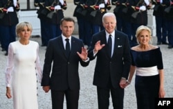 French first lady Brigitte Macron, French President Emmanuel Macron, U.S. President Joe Biden and U.S. first lady Jill Biden pose ahead of an official state dinner as part of Biden's state visit to France, at the Presidential Elysee Palace in Paris on June 8, 2024.