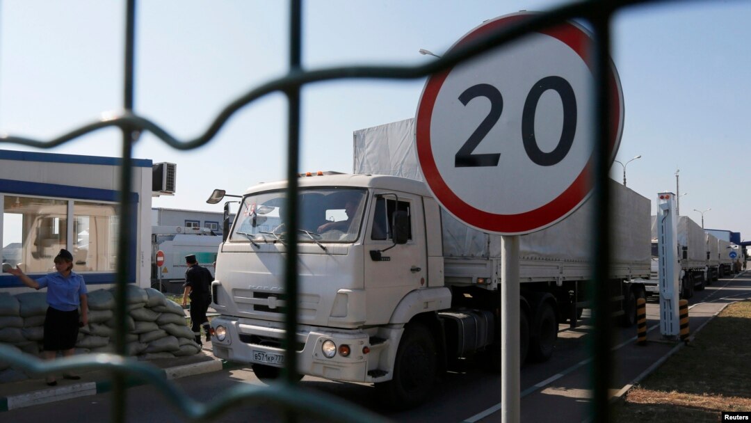 Trucks from a convoy that delivered humanitarian aid for Ukraine move back to Russia, Aug. 23, 2014. 