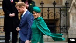 FILE - Britain's Prince Harry, Duke of Sussex, and Meghan, Duchess of Sussex, arrive to attend the annual Commonwealth Service at Westminster Abbey in London, March 9, 2020.