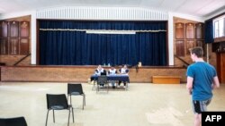 FILE —Electoral Commission of South Africa officials wait for voters to be registered at the Rosebank Primary School voting station during the nationwide voter registration campaign ahead of the 2024 general elections in Johannesburg on November 18, 2023.