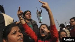 Demonstrators shout slogans near the presidential palace during a protest in New Delhi, Dec. 22, 2012. 