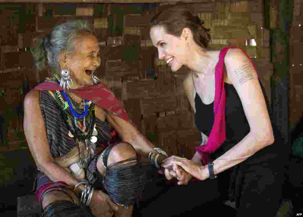 Actress Angelina Jolie, a United Nations High-Commissioner for Refugees (UNHCR) Special Envoy, meets Baw Meh, age 75, from Myanmar, at the Ban Mai Nai Soi refugee camp near the border with Thailand. (AFP/UNHCR/Roger Arnold)