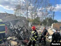 Tim penyelamat bekerja di lokasi serangan militer Rusia, di tengah serangan Rusia ke Ukraina, di Desa Hroza, di wilayah Kharkiv, Ukraina 5 Oktober 2023. (Foto: via Reuters)