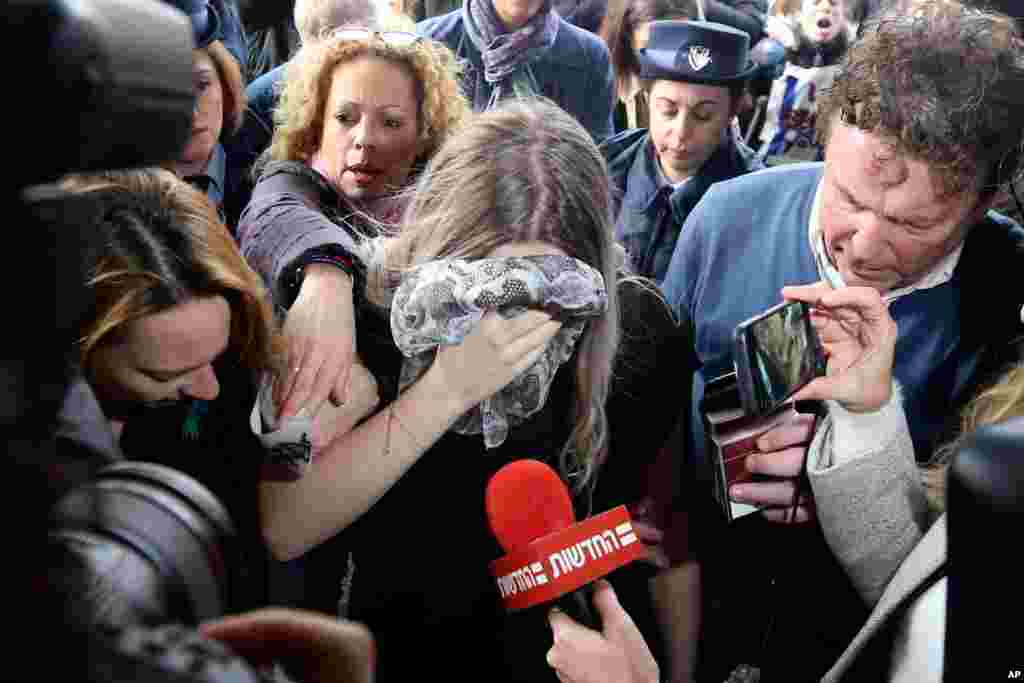 A 19 year-old British woman, center, who was found guilty of making up claims that she was raped by up to 12 Israelis, arrives at Famagusta District Court for sentencing in Paralimni, Cyprus. 