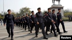 Thai police officers gather in Bangkok on Dec. 30, 2013, calling for justice after one policeman was shot dead and many injured during last week's clash with anti-government protesters. 