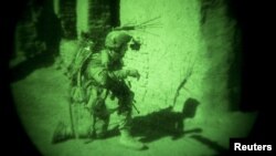 A coalition soldier in Afghanistan is seen through a night vision device (file photo).