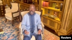 FILE - Gabon's ousted president, Ali Bongo, makes a statement through a video message, after the Gabon military seized power, at an unknown location, in this screen grab taken from a social media video released on Aug. 30, 2023.