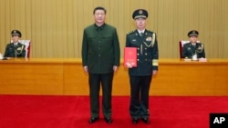 Chinese President Xi Jinping stands with Chen Hui, who was named political commissar of the army and promoted to the rank of senior general, at a ceremony in Beijing, Dec. 23, 2024. (Xinhua via AP)