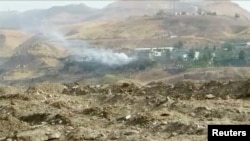 Smoke rises from buildings at the site of a car bomb explosion at a police headquarters in Cizre, located in Turkey's Sirnak province bordering both Syria and Iraq, in this still image from video, Aug. 26, 2016. 