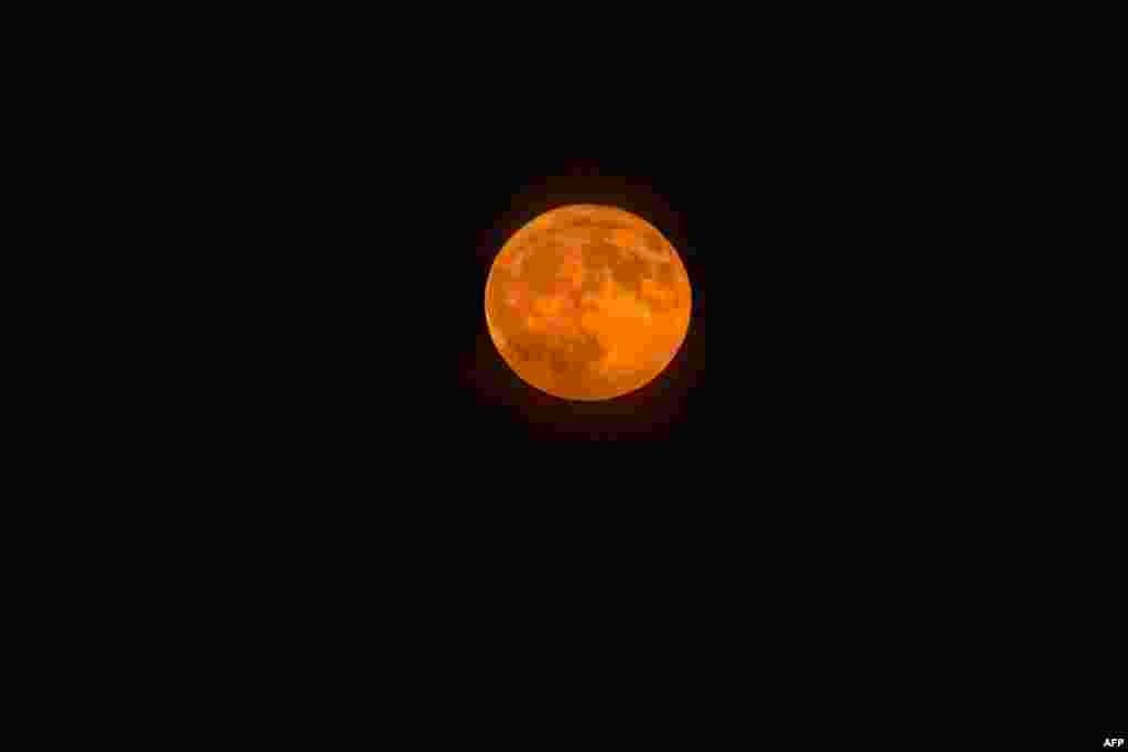 A blue supermoon rises above Boston Harbor in Boston, Massachusetts on Aug. 19, 2024.