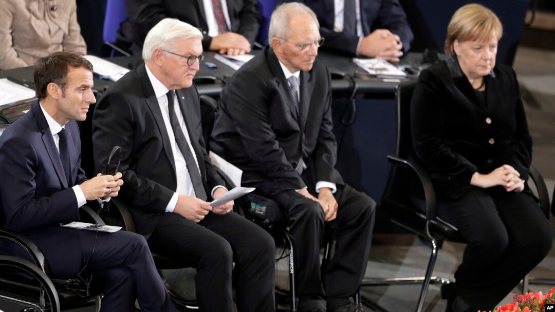 France's President Macron, German President Steinmeier, Wolfgang Schaeuble, President of the German Federal Parliament, and German Chancellor Merkel attend a meeting of the Bundestag in Berlin, Nov. 18, 2018, Germany's national day of mourning.