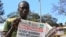 FILE - A news vendor displays newspapers in the Ugandan capital Kampala, Oct. 6, 2014. The World Health Organization is currently part of an effort working to rapidly contain an outbreak of the deadly Marburg virus disease in eastern Uganda on the border with Kenya, Oct. 20, 2017.