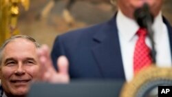 EPA administrator Scott Pruitt listens as President Donald Trump speaks before signing the Waters of the United States executive order, Feb. 28, 2017, in the Roosevelt Room of the White House.