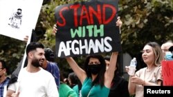 Paris Sharifie, an Afghan-American immigrant originally from Herat, displays a placard reading "Stand With Afghans" at a rally against the Taliban and developments in Afghanistan during a demonstration in downtown Los Angeles, California, U.S., August 21…