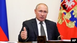 Russian President Vladimir Putin gestures during a meeting with elected heads of Russian regions via video conference at the Novo-Ogaryovo residence outside Moscow, Russia, Thursday, Sept. 24, 2020. Russian health officials have reported 6,595 new…