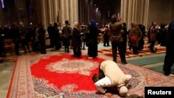 Omar Abdul-Malik prays alone as the Washington National Cathedral and five Muslim groups hold the first celebration of Muslim Friday Prayers, Jumaa, in the Cathedral's North Transept in Washington, D.C., Nov. 14, 2014. 