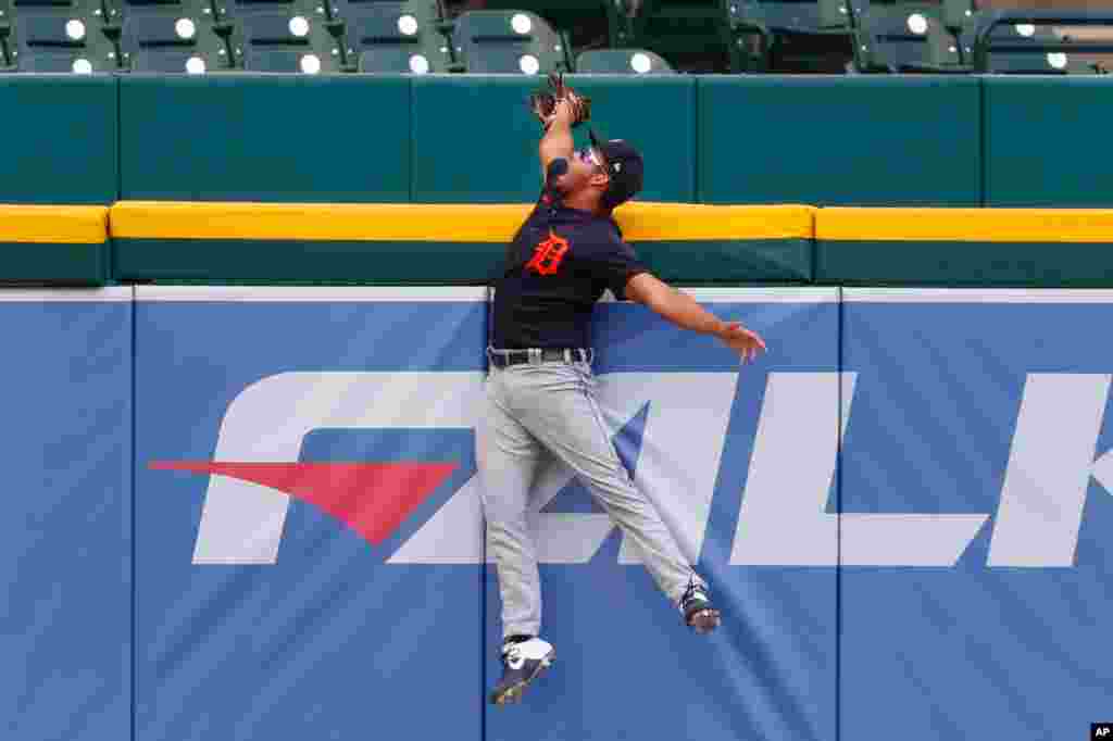 Detroit Tigers left fielder Riley Greene catches a C.J. Cron hit from over the outfield wall to save a home run during an intrasquad baseball game in Detroit, Michigan.