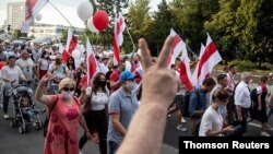 People march in solidarity with the people of Belarus following the country's disputed presidential election, in Bialystok, Poland, Aug. 20, 2020.