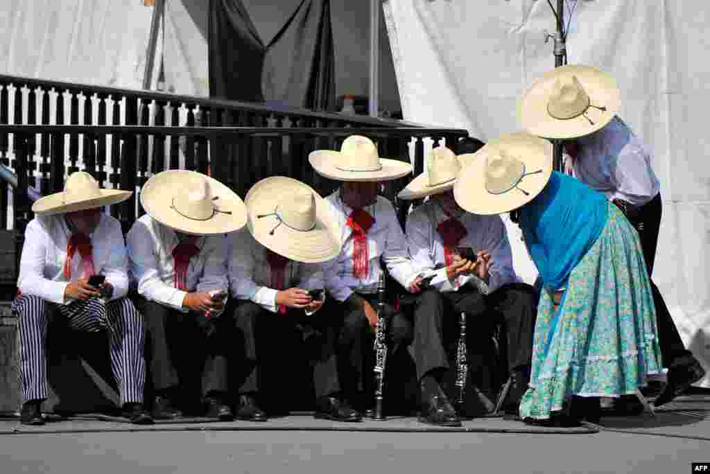 People wait to perform in a parade commemorating the 109th anniversary of the Mexican Revolution in Mexico City, Nov. 20, 2019.