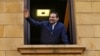 Lebanese Prime Minister Saad Hariri waves to his supporters from a window of his residence, in Beirut, Lebanon, Nov. 22, 2017. 