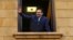 Lebanese Prime Minister Saad Hariri waves to his supporters from a window of his residence, in Beirut, Lebanon, Nov. 22, 2017. 
