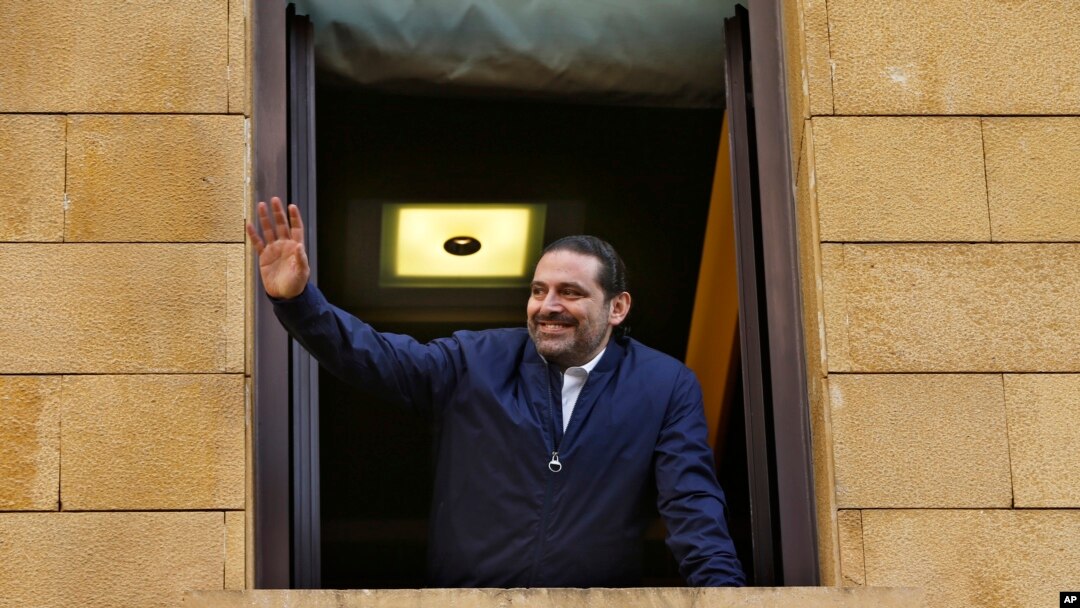 Lebanese Prime Minister Saad Hariri waves to his supporters from a window of his residence, in Beirut, Lebanon, Nov. 22, 2017. 