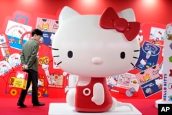 A visitor looks at giant Hello Kitty display at the exhibition "As I change, so does she," marking the 50th anniversary of Hello Kitty at the Tokyo National Museum in Tokyo, Oct. 30, 2024.