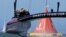 Oracle Team USA crosses the finish line during the 18th race of the America's Cup sailing event against Emirates Team New Zealand, Sept. 24, 2013, in San Francisco.