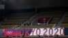 People walk through an empty section of spectator stands during judo competition at the 2020 Summer Olympics, July 24, 2021, in Tokyo, Japan. 