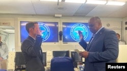 FILE - U.S. Defense Secretary Lloyd Austin, right, swears in Ely Ratner as the assistant secretary of defense for Indo-Pacific security affairs, aboard a military plane, July 25, 2021. Ratner has discussed U.S.-China defense relations with a Chinese foreign ministry official. 