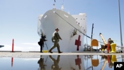 The USNS Mercy hospital ship is prepared for departure on March 23, 2020, in San Diego.