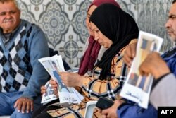 FILE—Family members of Tunisian migrants who were lost at sea in January gather with their pictures in Hencha, about 45 kilometers north of Sfax in central Tunisia, on April 23, 2024.