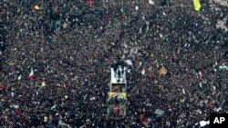 Coffins of Gen. Qassem Soleimani and others who were killed in Iraq by a U.S. drone strike, are carried on a truck surrounded by mourners during a funeral procession, in the city of Mashhad, Iran, Jan. 5, 2020.