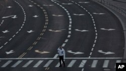 A Jewish man holds his head covering as he crosses an intersection at the gateway to Jerusalem, just after sunset and the start of Yom Kippur, Wednesday, Sept. 15, 2021. Yom Kippur is Judaism's day of atonement, when devout Jews ask God to forgive…