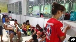 In this Philippine Red Cross photo, families are pictured at a temporary evacuation center at Catanduanes province, eastern Philippines, Nov. 1, 2020, as Typhoon Goni approaches.