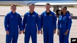 FILE - The SpaceX crew, from left, cosmonaut Alexander Grebenkin, pilot Michael Barratt, commander Matthew Dominick and mission specialist Jeanette Epps pose after arriving at the Kennedy Space Center in Cape Canaveral, Florida, Feb. 25, 2024.