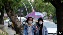 Women wearing face masks to protect against the new coronavirus, walk in a popular street, in Ankara, Turkey, June 15, 2020.